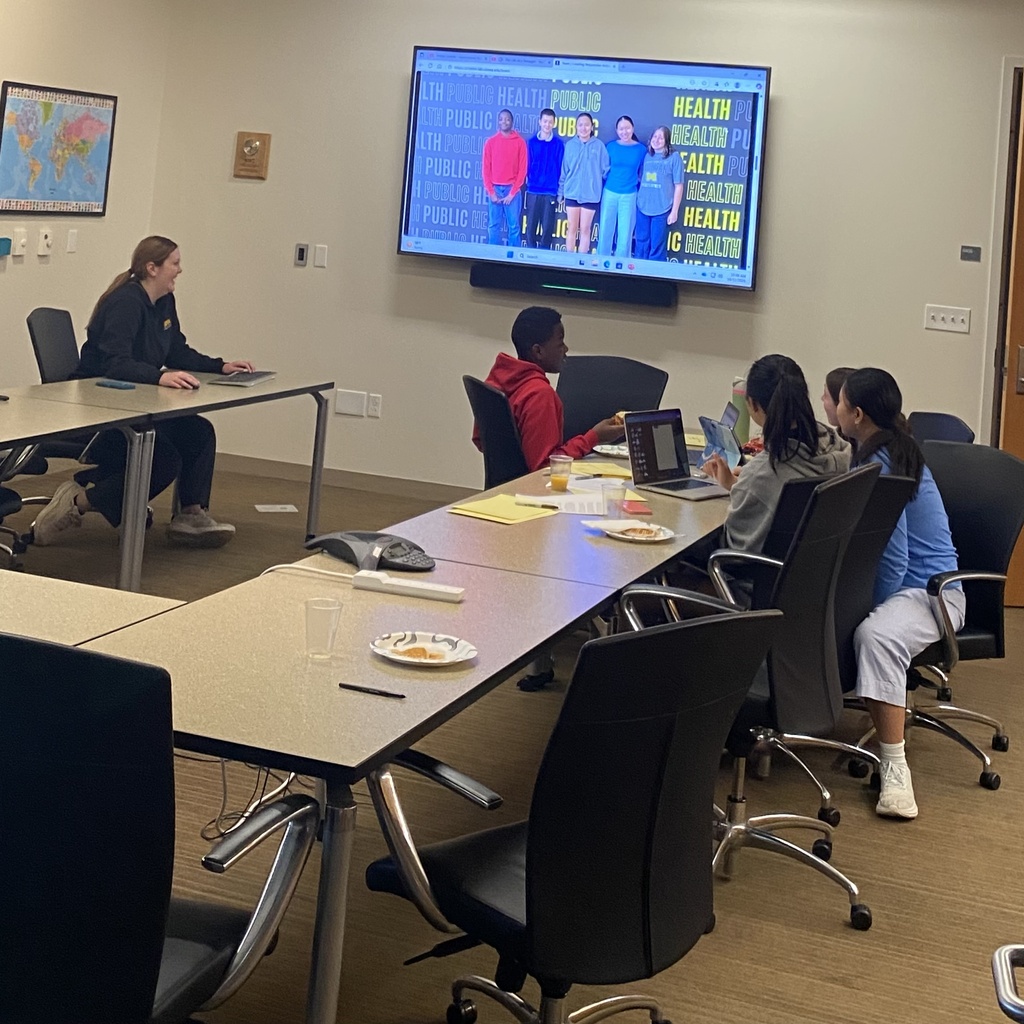 Picture of 4 teens working at a table developing content